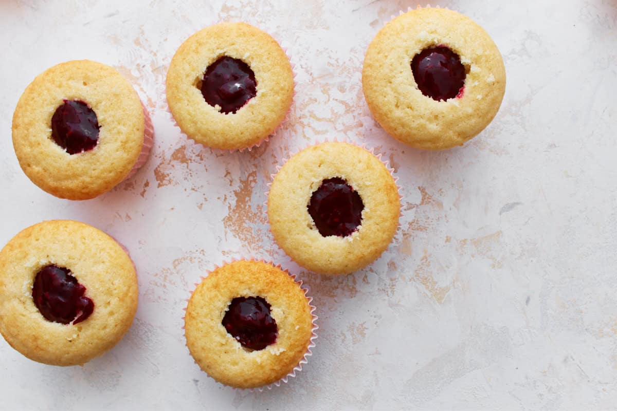 Cupcakes with the center removed and replaced with berry filling.