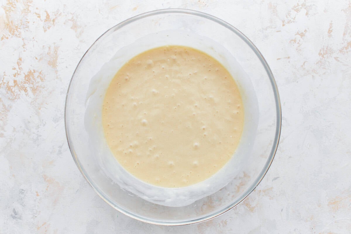 Cupcake batter in a glass mixing bowl.