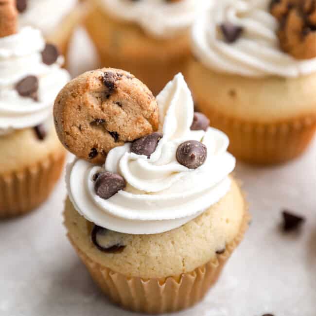 Cupcakes with chocolate chips and topped with mini cookies.