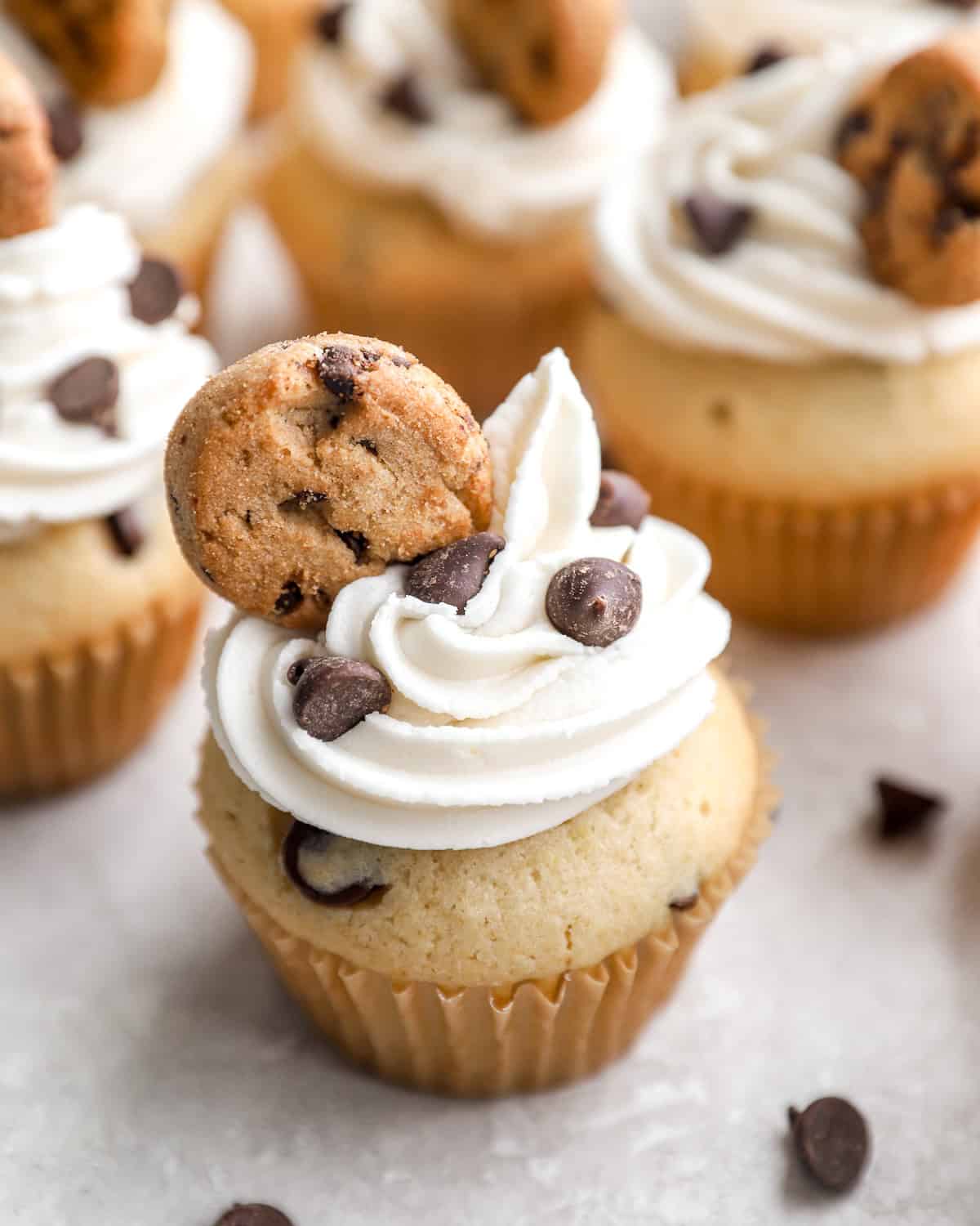 Cupcakes with chocolate chips and topped with mini cookies.