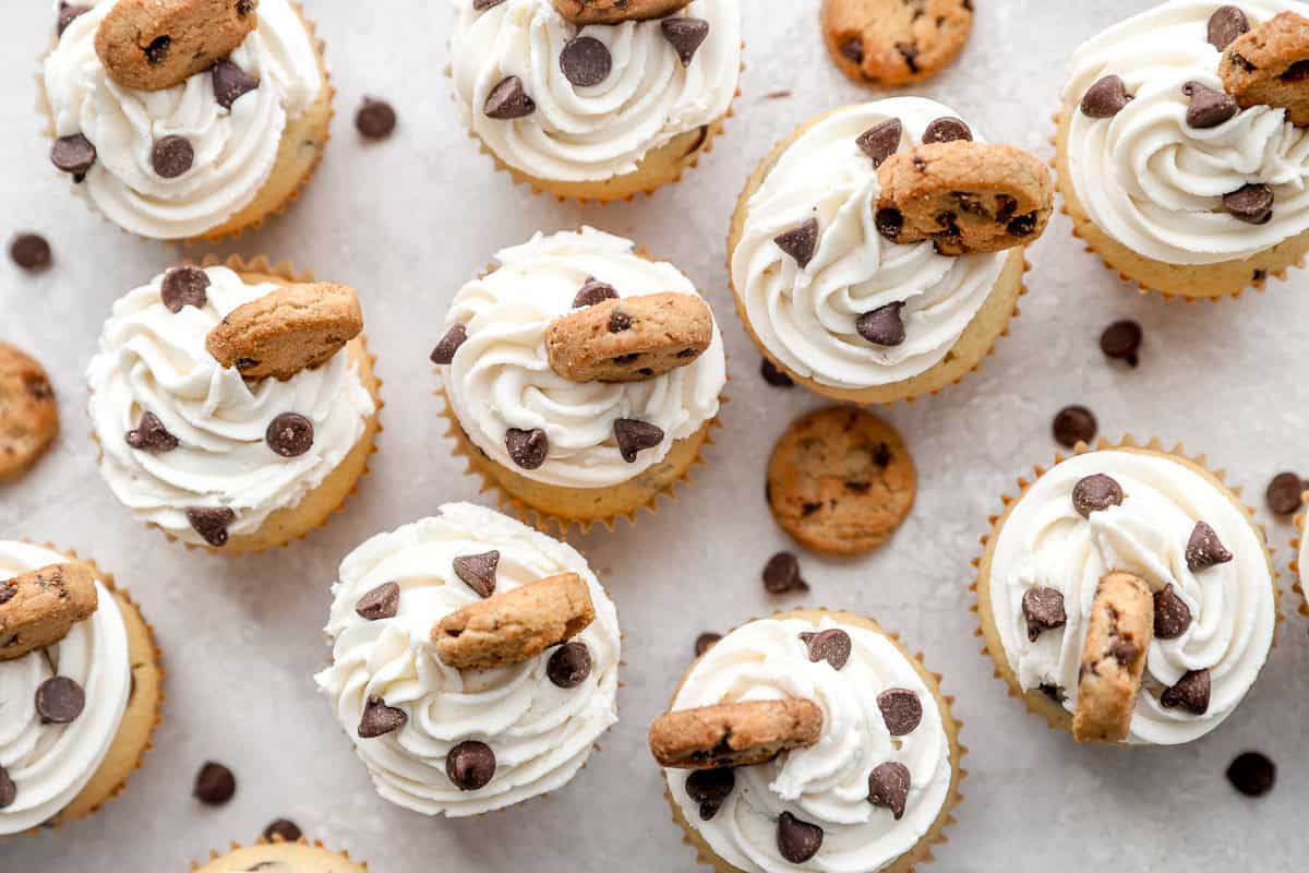 Overhead view of cupcakes lined up, sprinkled with chocolate chips.