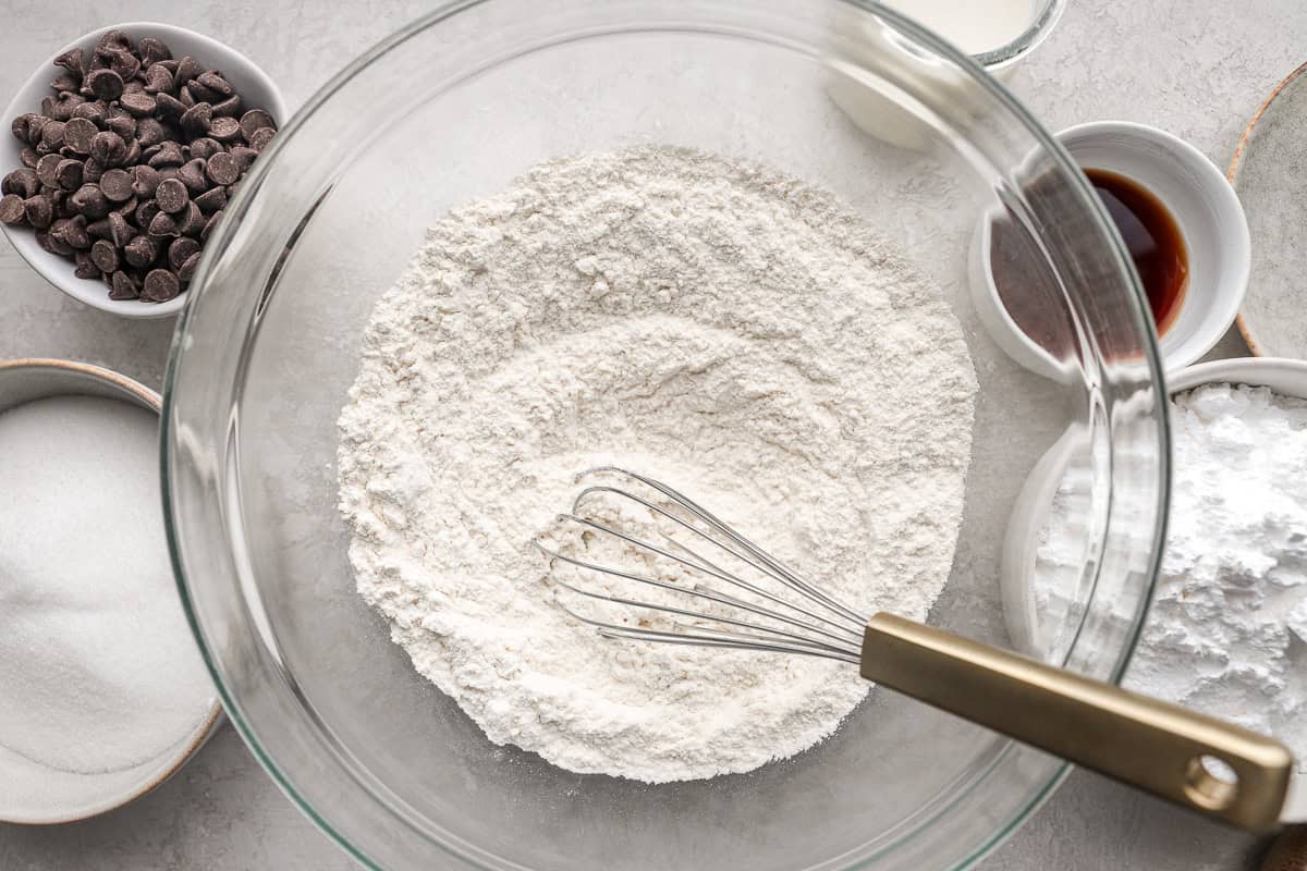 Dry ingredients in a mixing bowl with a whisk.