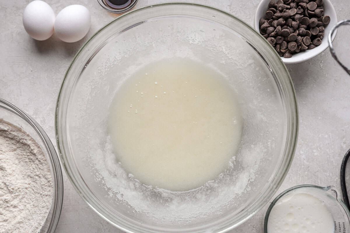 Oil and sugar mixture in a mixing bowl.