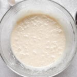 Cupcake batter in a glass mixing bowl.