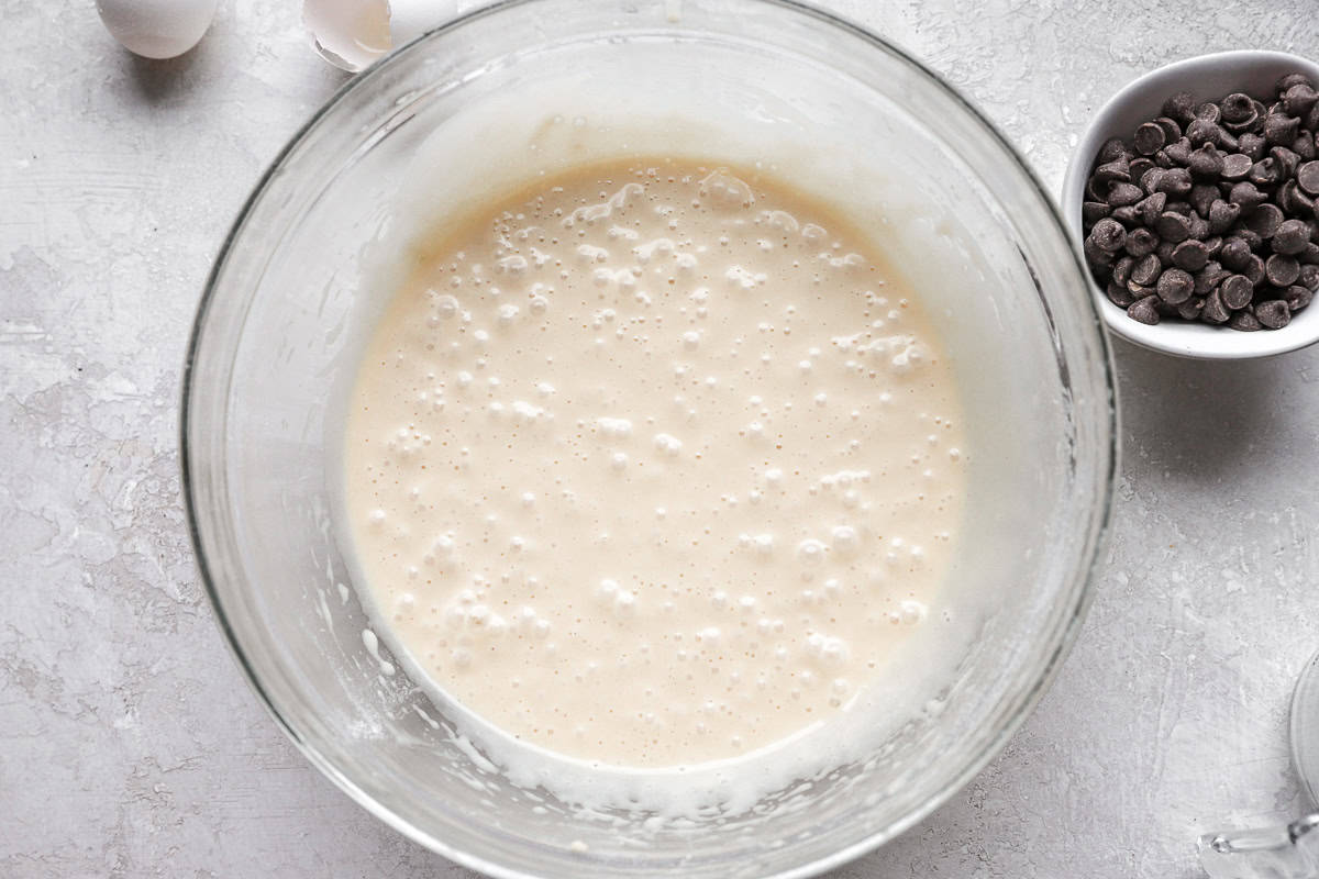 Cupcake batter in a glass mixing bowl.