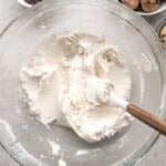 Buttercream frosting in a glass mixing bowl.