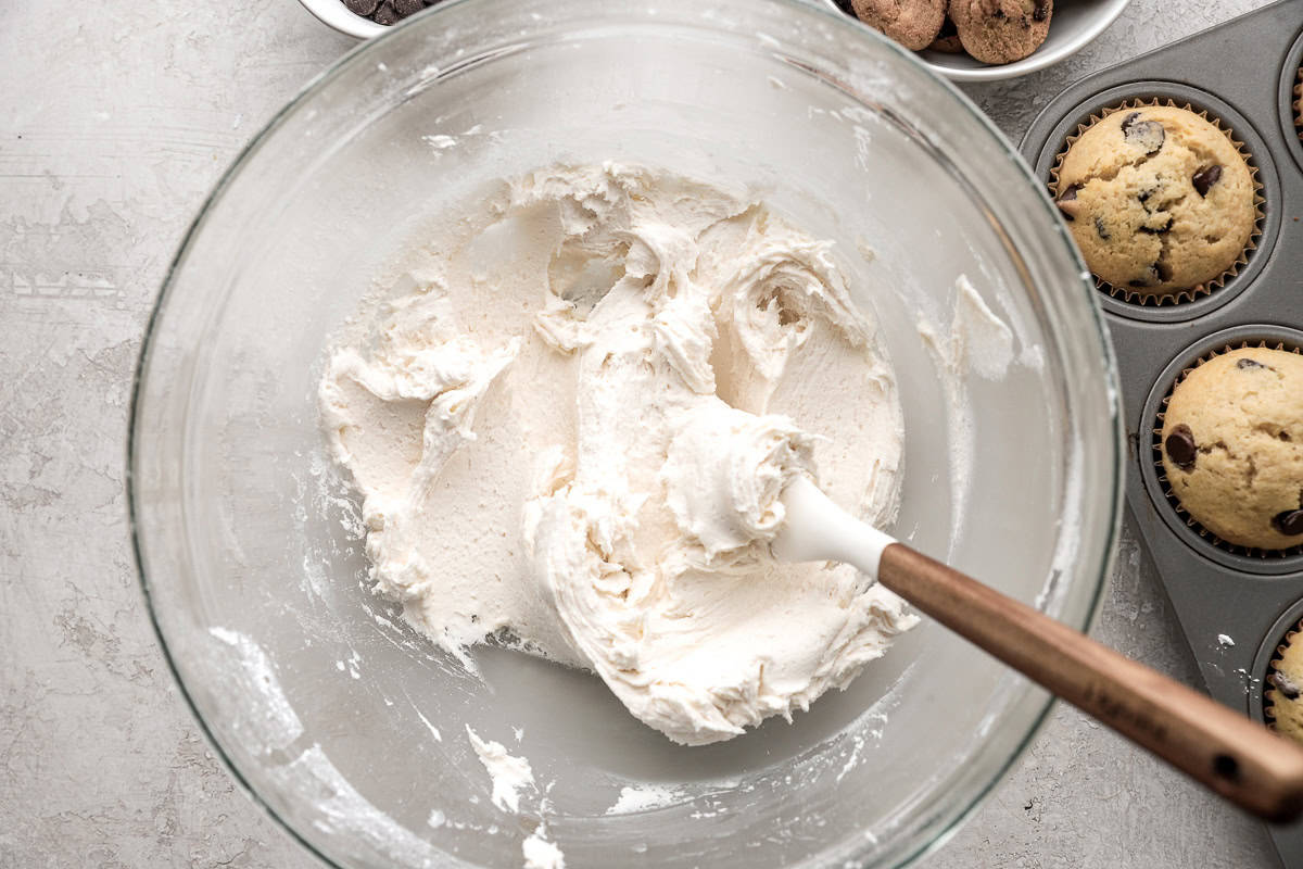 Buttercream frosting in a glass mixing bowl.