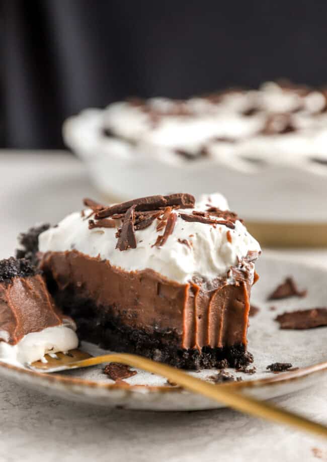 A slice of chocolate cream pie on a plate.