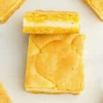a lemon cake bar leaning up against another bar to show the layers.