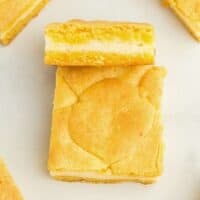 a lemon cake bar leaning up against another bar to show the layers.