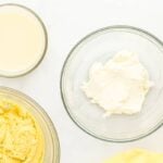 beaten cream cheese in a glass bowl.
