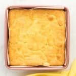 baked lemon cake bars in a square baking pan.