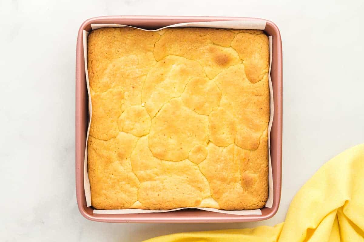 baked lemon cake bars in a square baking pan.