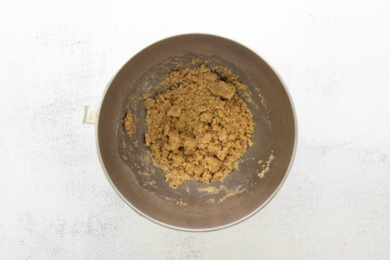 brown sugar shortbread cookie dough in a stainless mixing bowl.