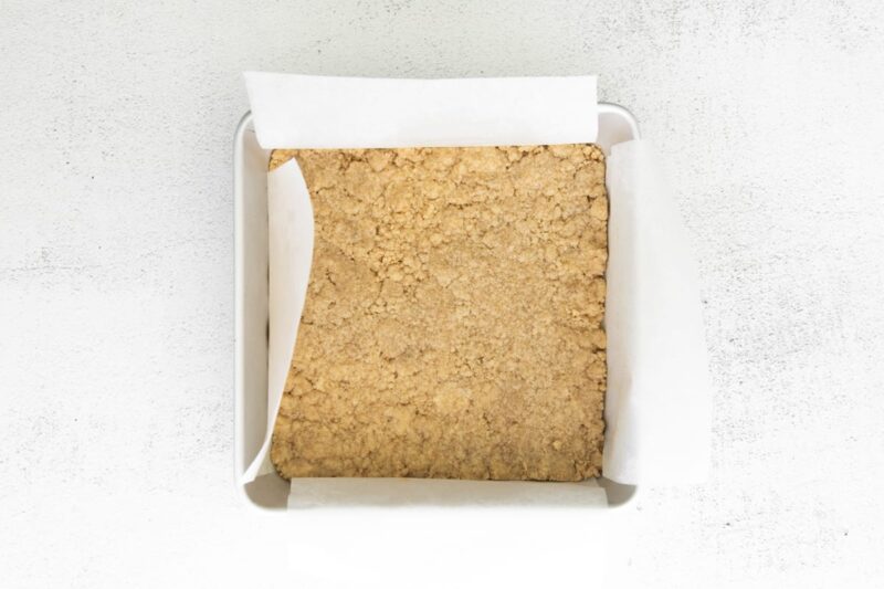 baked brown sugar shortbread crust in a lined square baking pan.