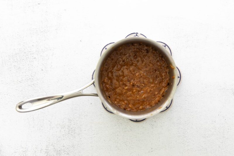 cooking soft caramels and shredded coconut in a saucepan.