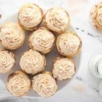 overhead view of frosted snickerdoodle cupcakes on a plate.