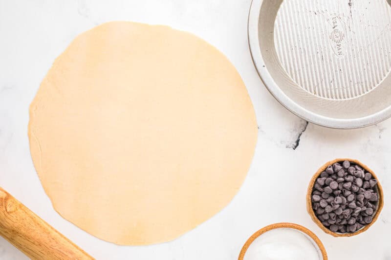 rolled-out pie crust on a work surface.