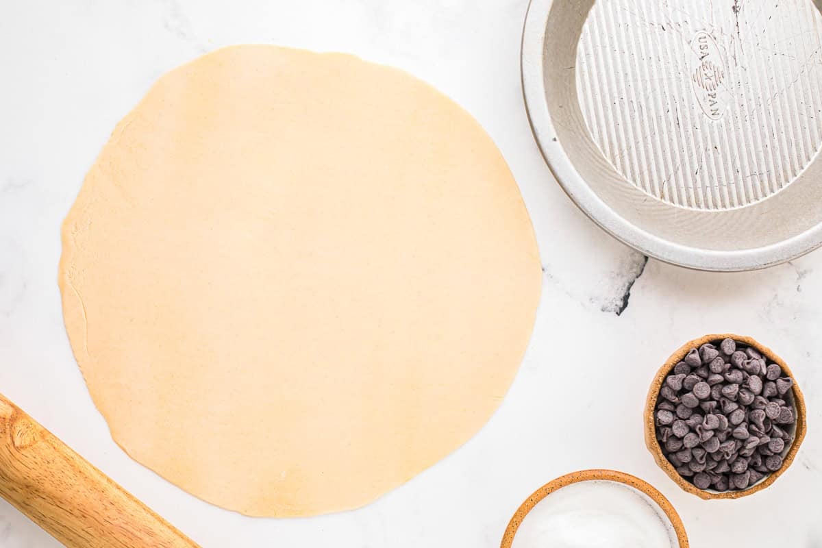 rolled-out pie crust on a work surface.