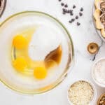 eggs, sugar, and vanilla in a glass bowl.