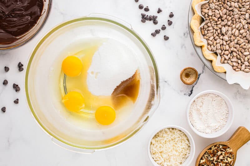 eggs, sugar, and vanilla in a glass bowl.