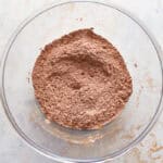 sifted dry ingredients (flour, cocoa, baking soda, salt) in a glass bowl.