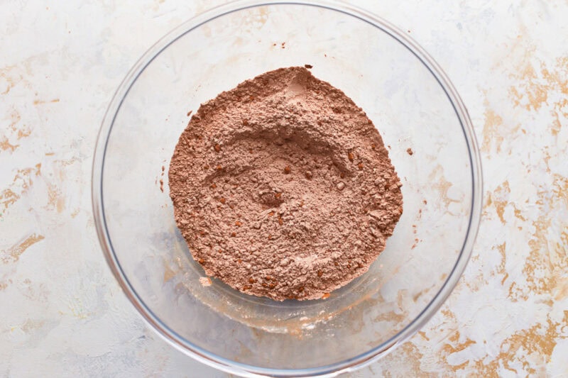 sifted dry ingredients (flour, cocoa, baking soda, salt) in a glass bowl.