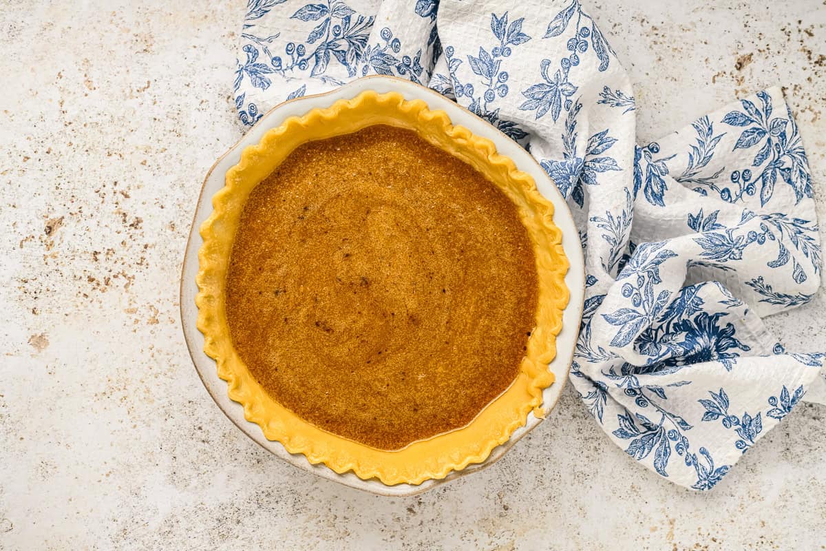 vinegar pie filling poured into a baked pie crust.