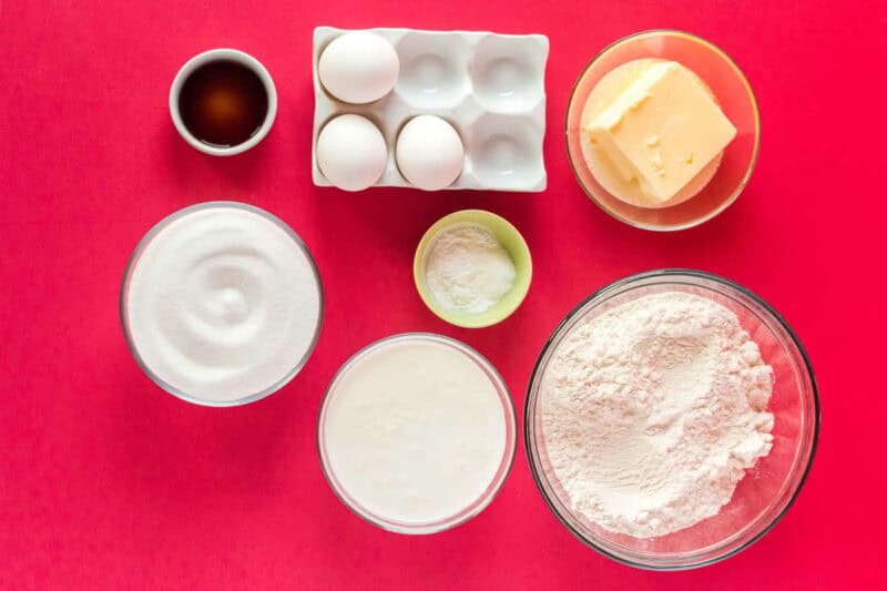 overhead view of portioned ingredients for peppermint santa cake in individual bowls.