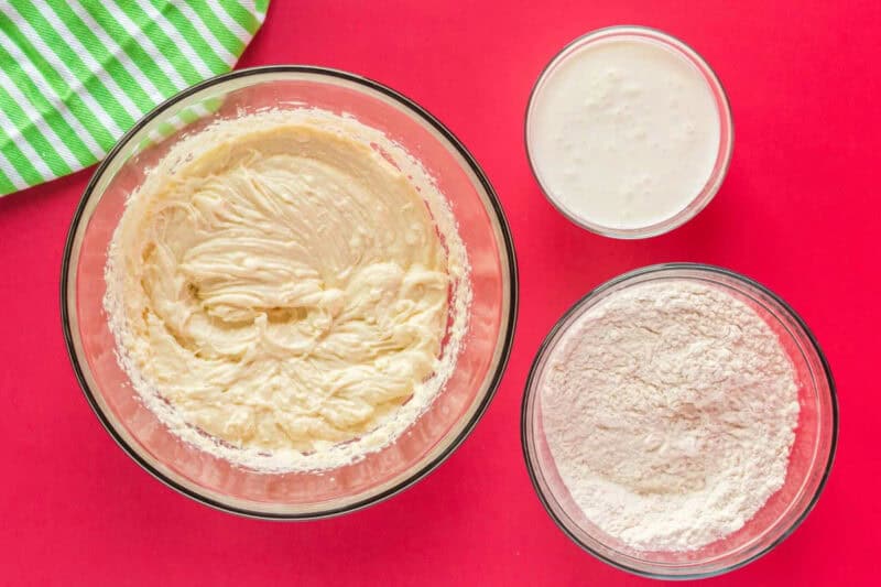 wet and dry ingredients for peppermint cake batter in glass bowls.
