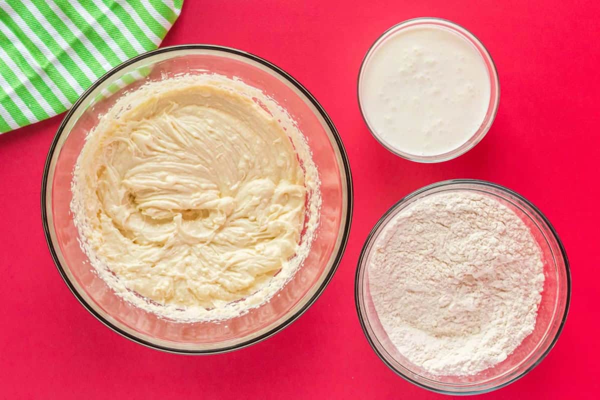 wet and dry ingredients for peppermint cake batter in glass bowls.