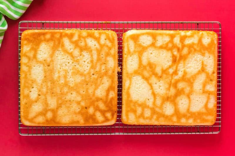 baked square peppermint cake layers on a cooling rack.