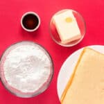 overhead view of ingredients for buttercream frosting in individual bowls.