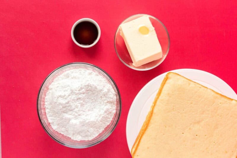 overhead view of ingredients for buttercream frosting in individual bowls.