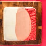 cake frosted with skin tone frosting and red for a hat.
