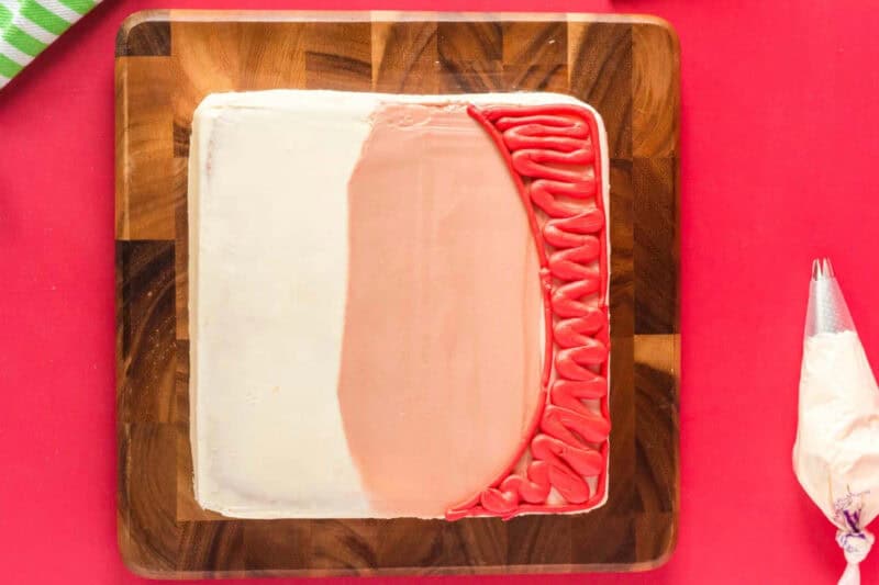 cake frosted with skin tone frosting and red for a hat.