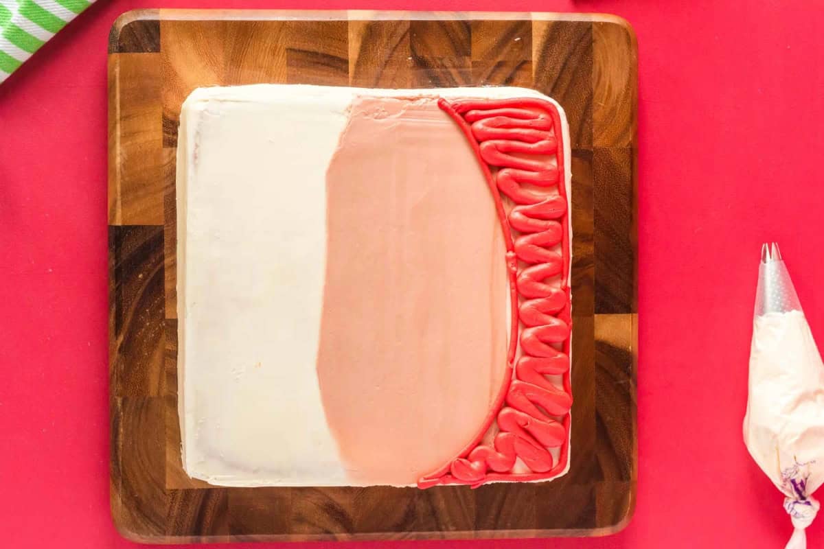 cake frosted with skin tone frosting and red for a hat.