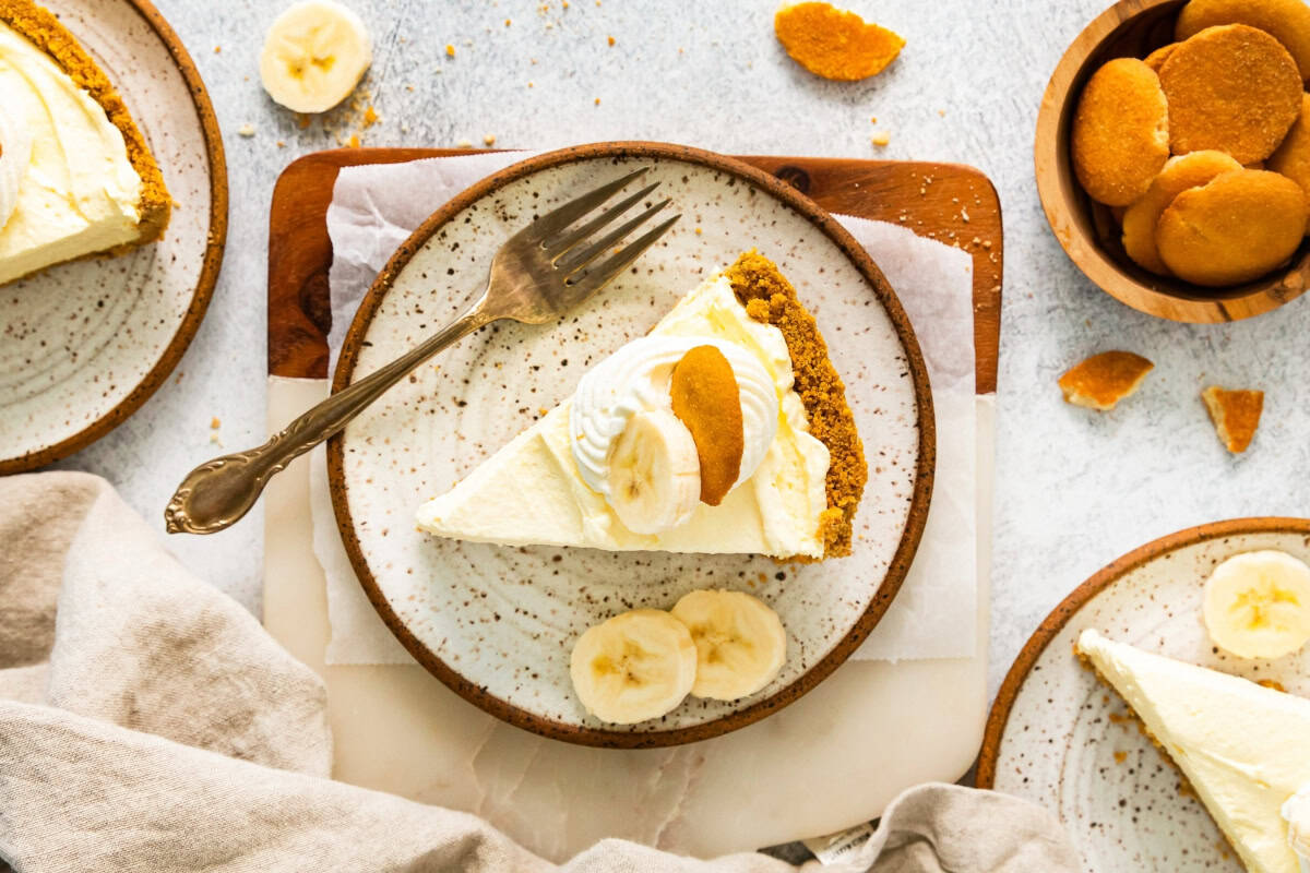 overhead view of a slice of banana pudding pie on a plate with a fork.