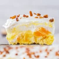 side view of a slice of twinkie cake on a spatula.