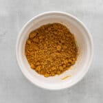 graham cracker crust mix in a white bowl.