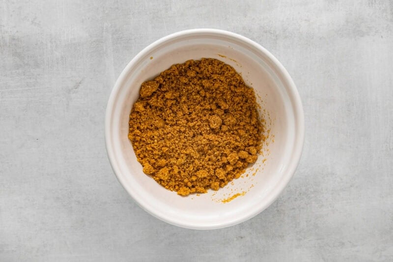 graham cracker crust mix in a white bowl.
