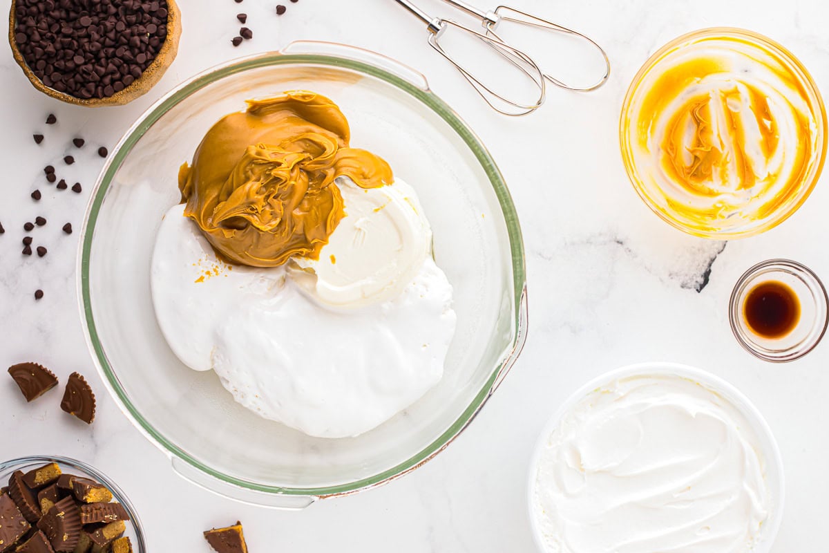 cream cheese spread, marshmallow, and peanut butter in a glass bowl.