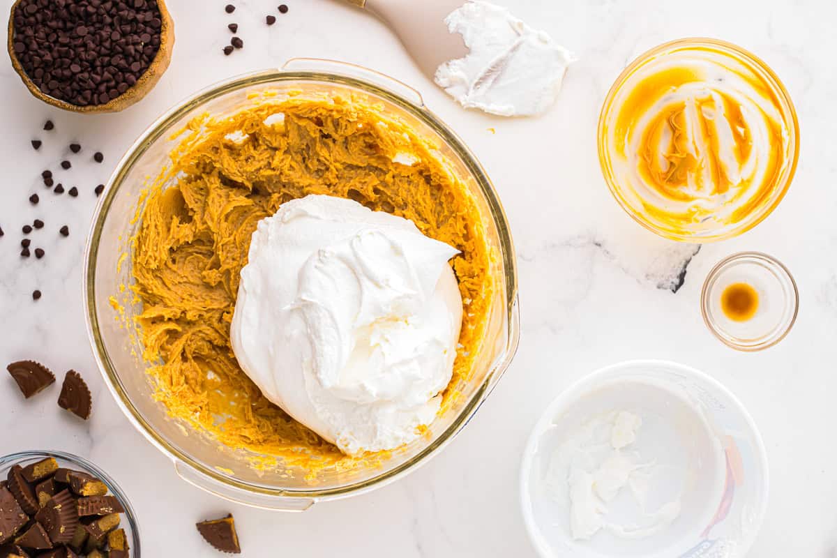 folding whipped topping into peanut butter fluff.