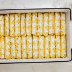 halved twinkies arranged filling-side-up in a baking pan.