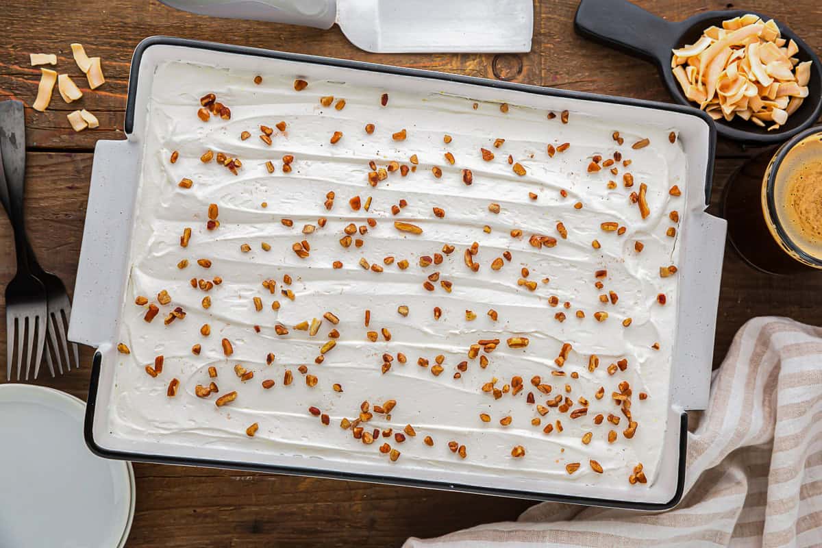 twinkie cake topped with whipped topping and coconut flakes.