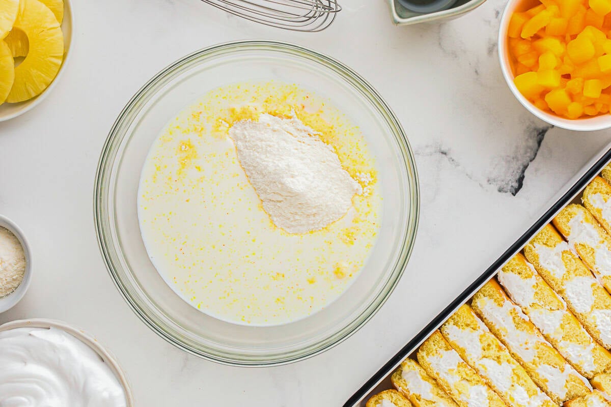instant pudding mix and milk in a glass bowl.
