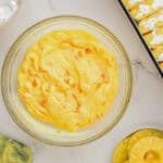 pudding with mango chunks in a glass bowl.