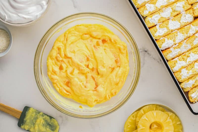 pudding with mango chunks in a glass bowl.