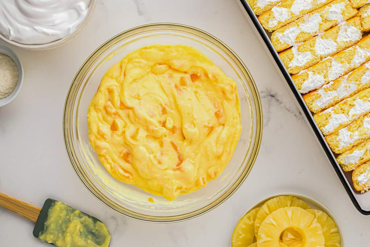 pudding with mango chunks in a glass bowl.