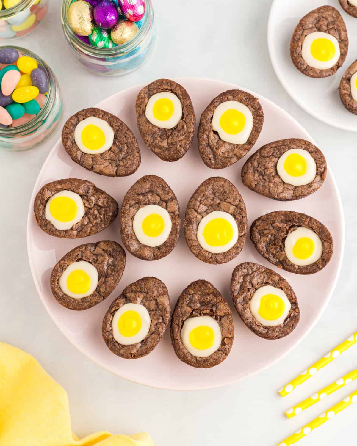 12 creme egg brownies arranged like deviled eggs on a circular tray.